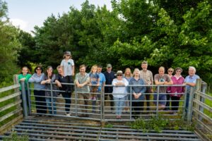 Group shot of CCDC Board, staff and supporters taken when they bought the land in June 2023